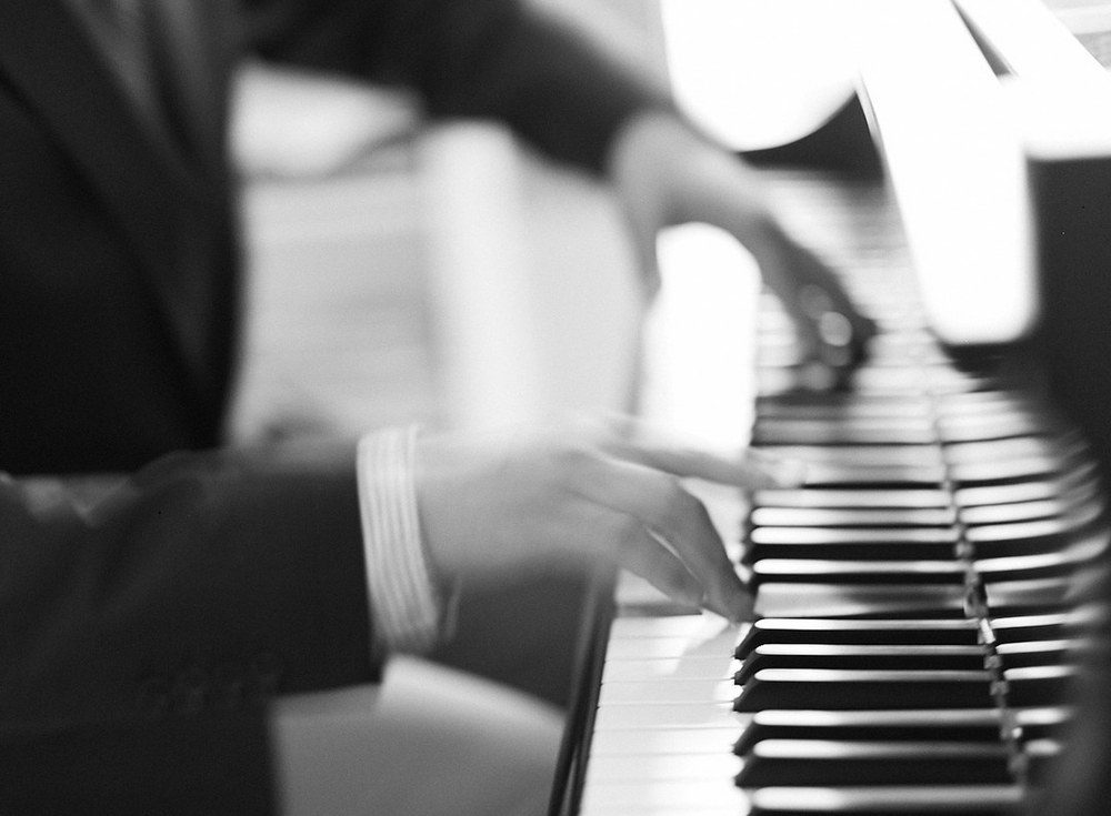 Joe Infurchia's hands on the keys, black and white