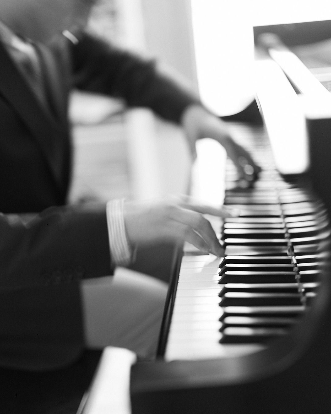 Joe Infurchia's hands moving across the keys, black and white